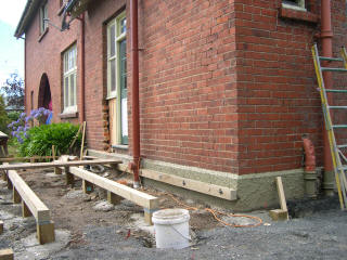 Foundations for the deck, with indications of french doors to come